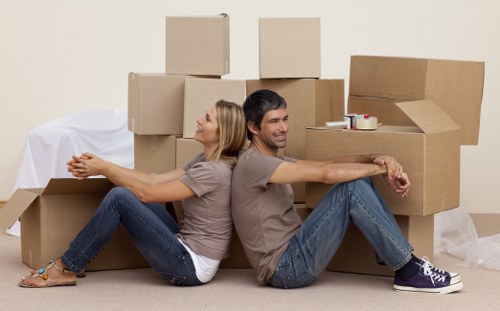 Removal team handling a flat move in Hampton with furniture and boxes