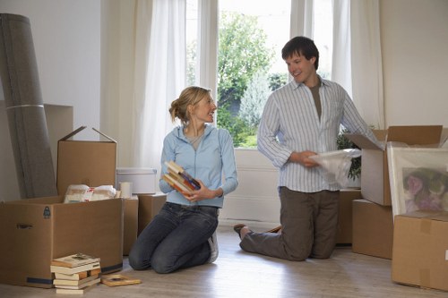 Professional movers carrying belongings from a Hampton apartment building